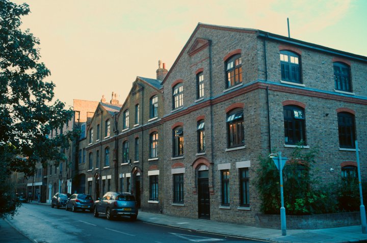 A row of brick apartment buildings along a quiet street